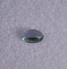Load image into Gallery viewer, Purple-Facing Chrome Kornerupine Cabochon with Teal Axis - 0.3 ct.