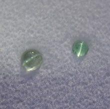 Load image into Gallery viewer, Set of Two Round Vanadium Bearing Cats Eye Kornerupine Gemstones - 0.71 ctw.
